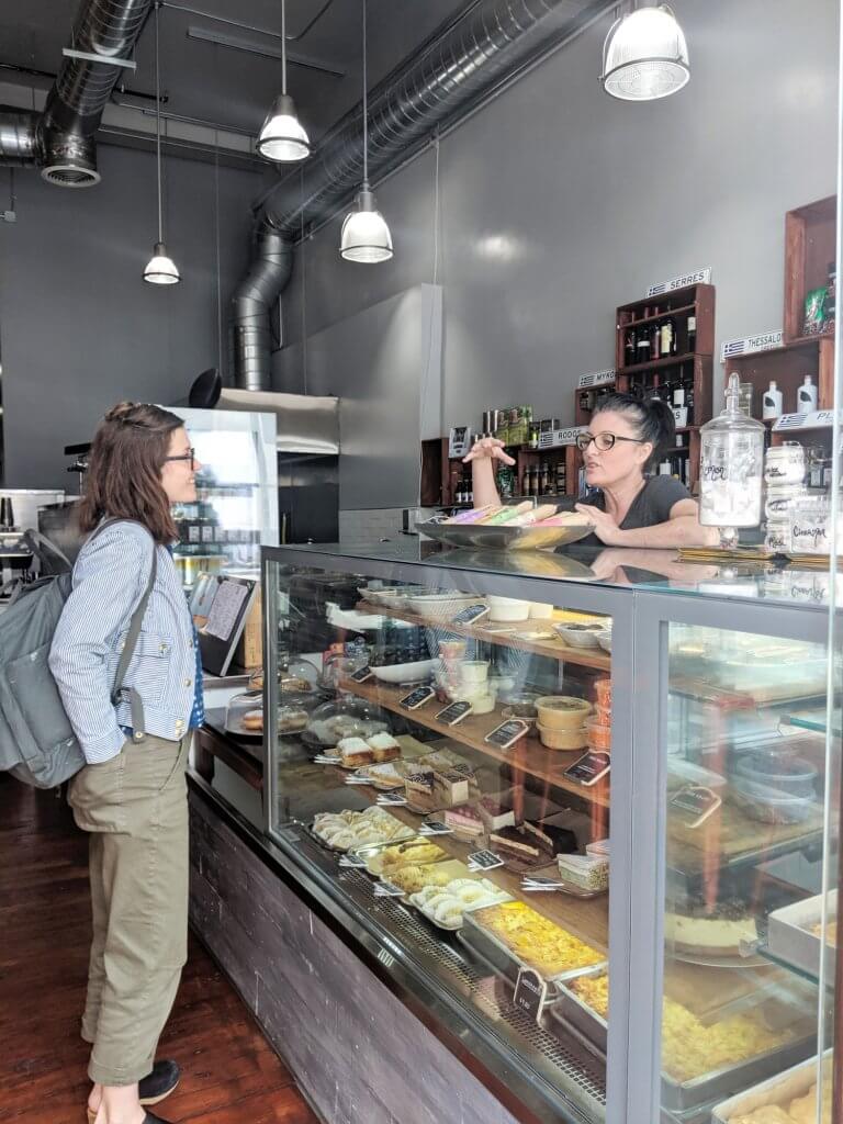 Cristelle is conducting an SF Shines interview with a small business owner at their place of work.