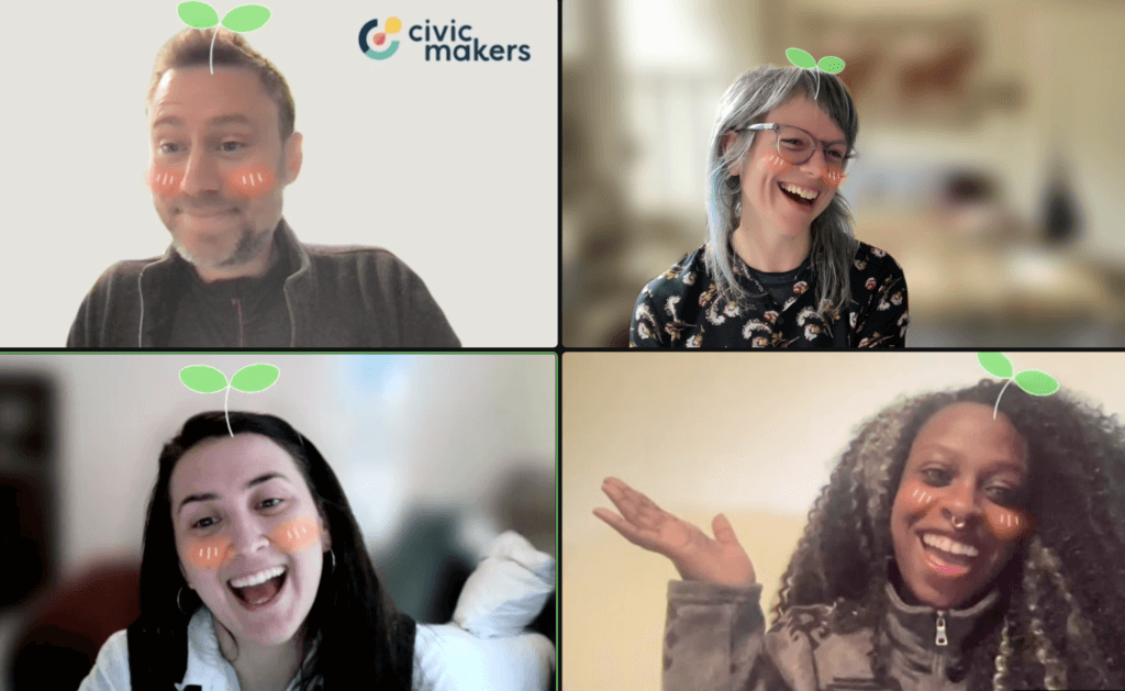 Mike, Judi, Leah, and Brit on a zoom call. All are smiling with the zoom filter of green sprouts coming from their heads.