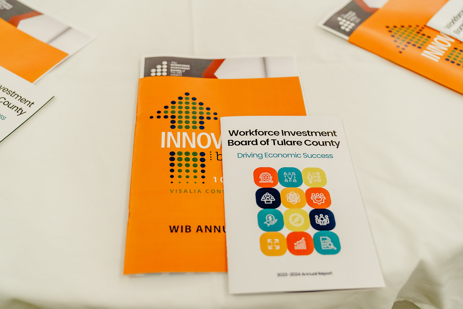 A picture of the conference handouts, arranged around the table for each attendee. This includes a handout for the conference and the WIB's Annual Plan.