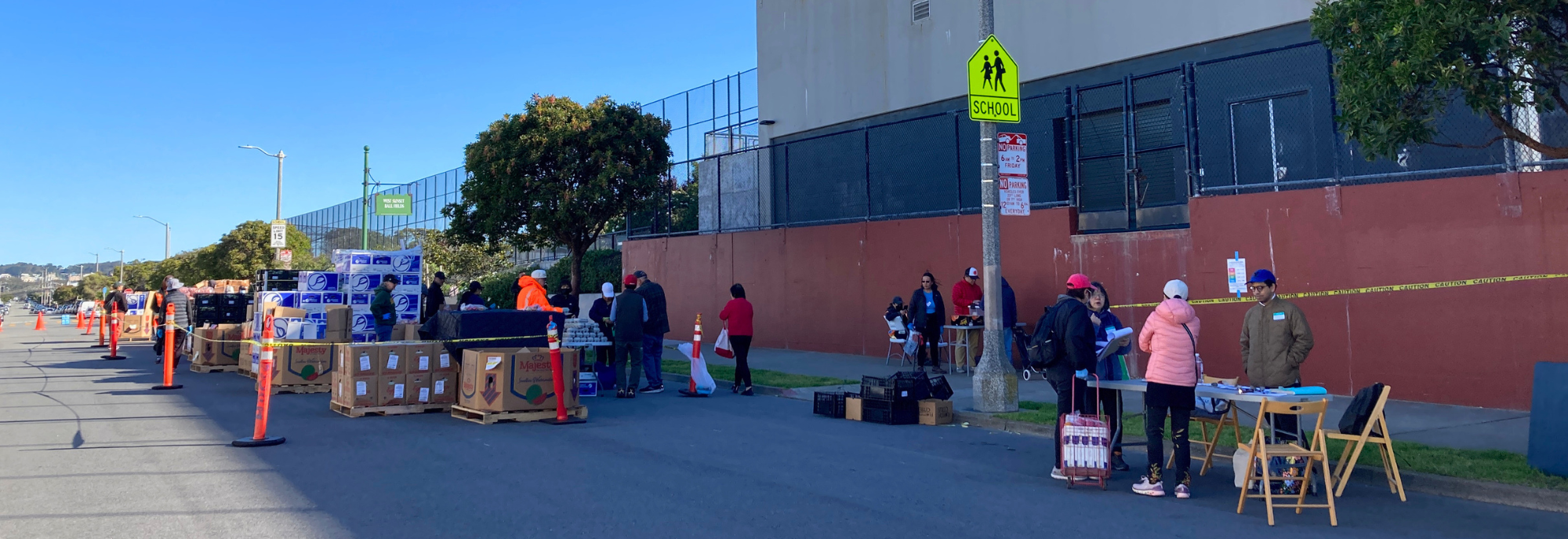 Photo taken at a pop-up food bank in the SF Sunset neighborhood. At the end of the food line-up is a table where the CivicMakers and SFHSA team conducted intercept surveys.
